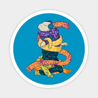 Winter manatee wrapped in scarves on snowy background Magnet